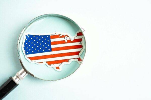 USA America flag and magnifying glass with copy space.